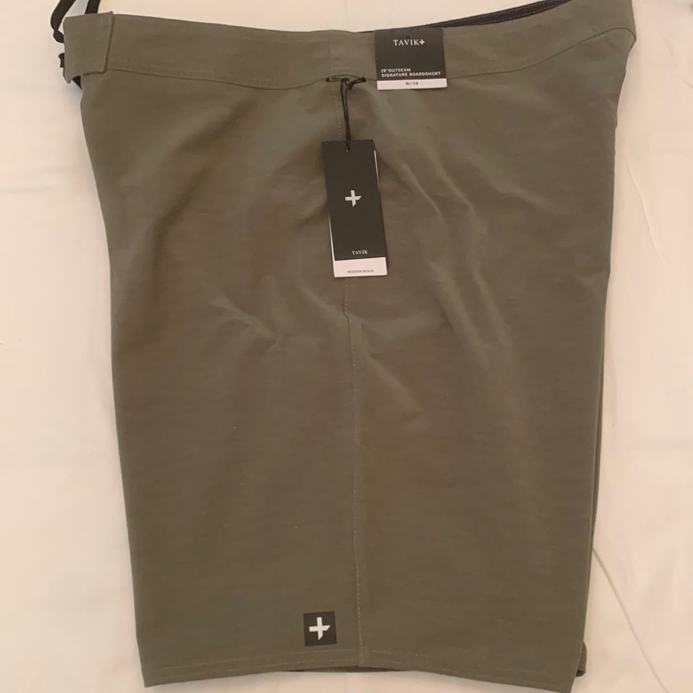 Tabuk, green with camo print board shorts.